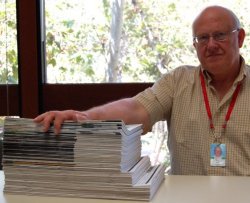 Body of Work: Editor Tom Miller with the 67 issues of ArcNews he has produced.