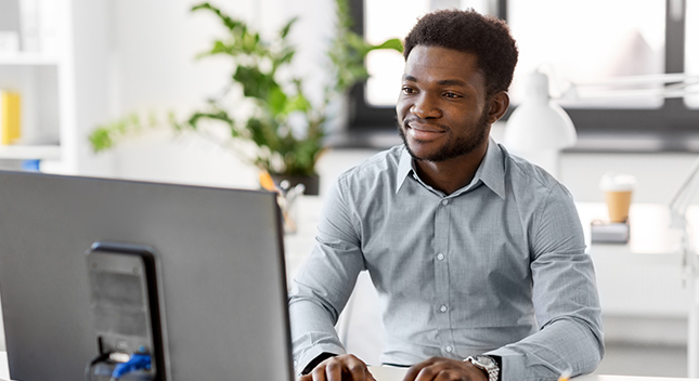 Black professional man working at a computer