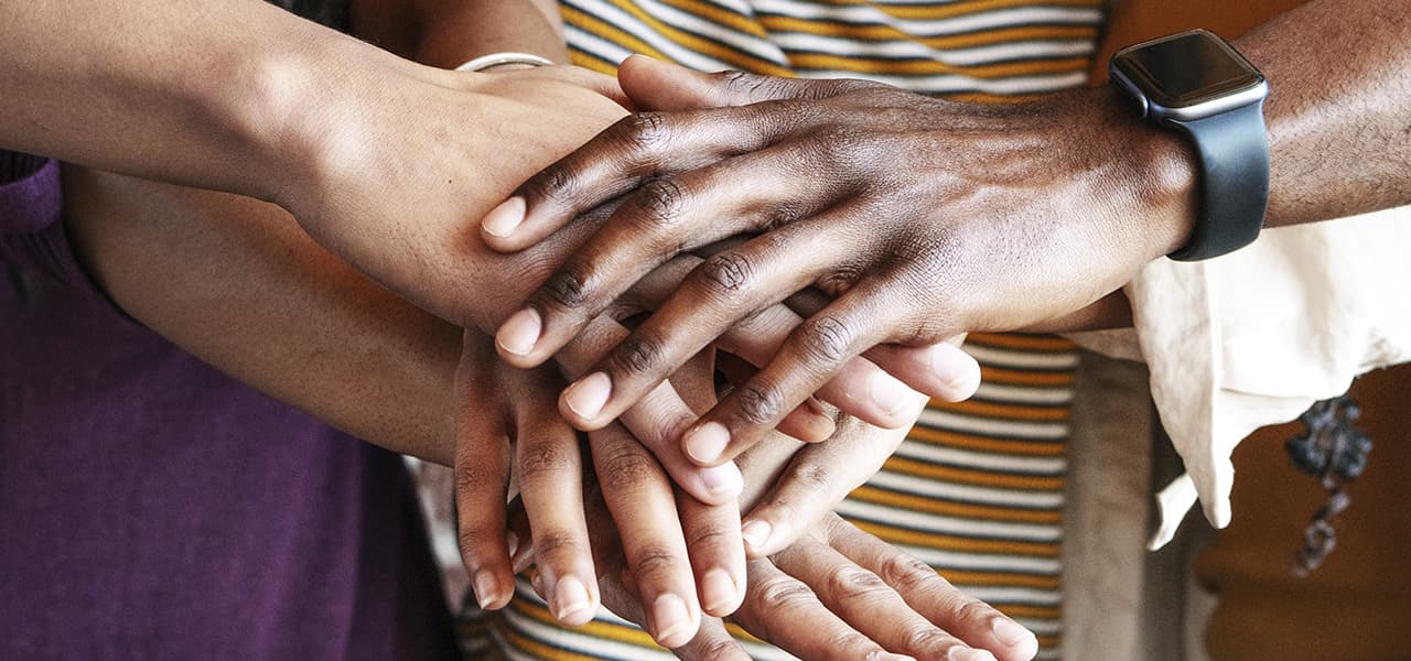 A gathering of hands from different races coming together