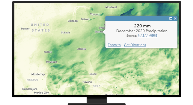 A desktop computer monitor displaying a precipitation map of Texas
