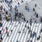 An aerial photo of a city intersection crowded with colorful pedestrians walking in all directions