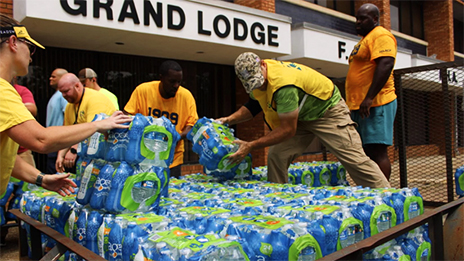 NAACP workers unloading a pallet of water bottles.