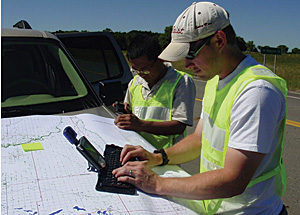 photo of 2 workers correlating data in the field
