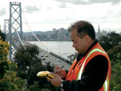 photo of workman entering field data at the Golden Gate Bridge