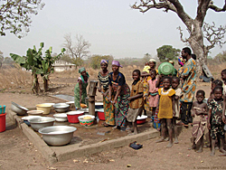people gathering water in a river catchment