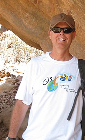 Dean Lambert professor of geography, wears his Esri T-shirt while visiting Laas Gaal