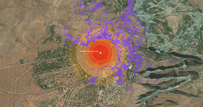 A map of Victoria Falls that centers on Baobab Primary School (represented by a bright red circle) and displays tracking points for the elephant (represented by purple dots), which show the elephant near the school, but not at it, a few times and, the rest of the time, outside the red circle