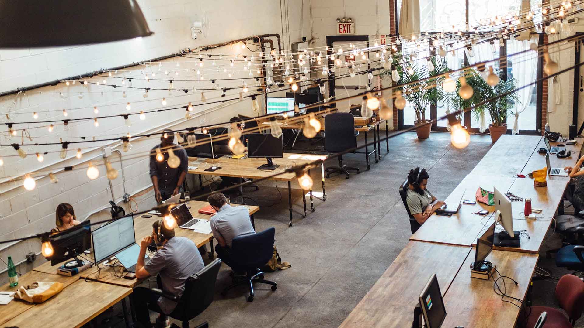 Workers in an open space where SMB innovation occurs