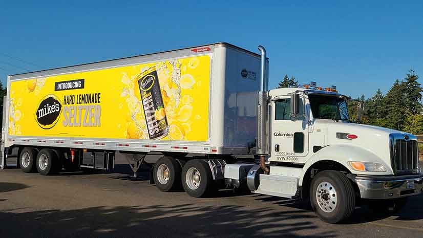 A Columbia Distributing truck featuring a swappable ad