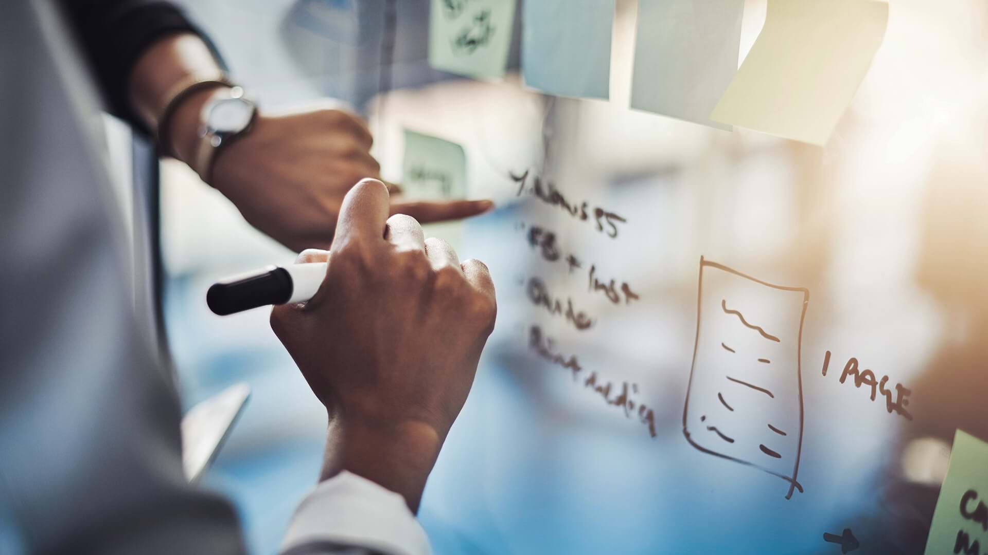 Professionals writing on a clear board represents the risk of AI exposure for certain jobs