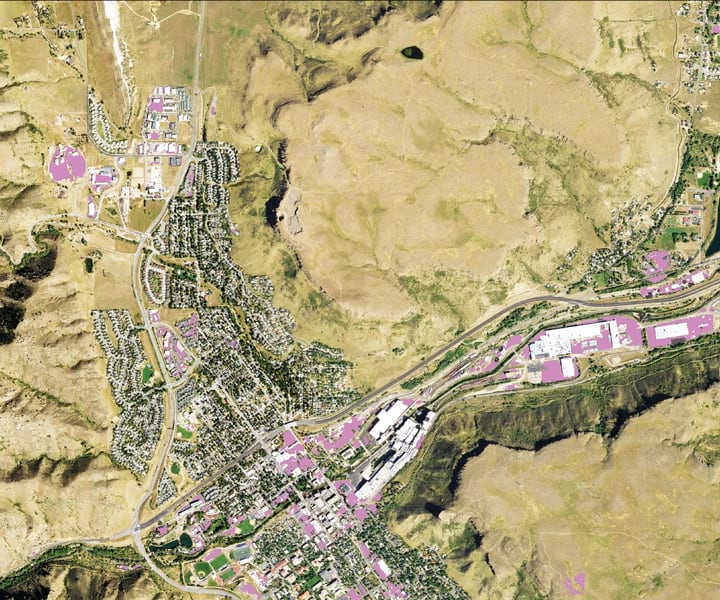 An aerial image of a city with some sections of it shaded in purple