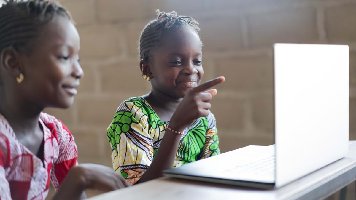A young girl smiling and learning