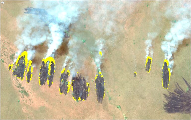 Highlighted imagery of burn scars across a smoking landscape.