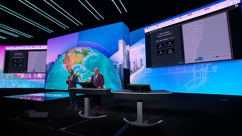 Two people standing on the plenary stage at the Esri User Conference