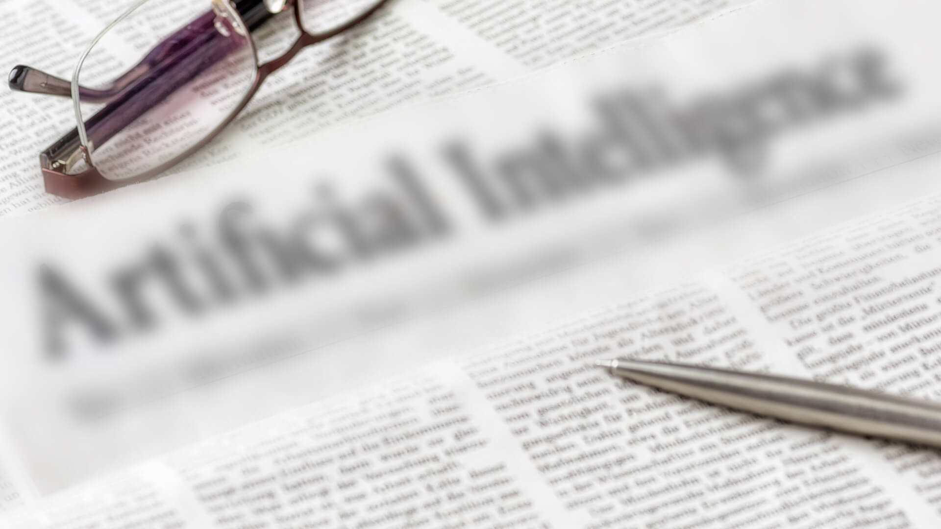 A blurred newspaper headline indicates that businesses may be overlooking analytical AI capabilities