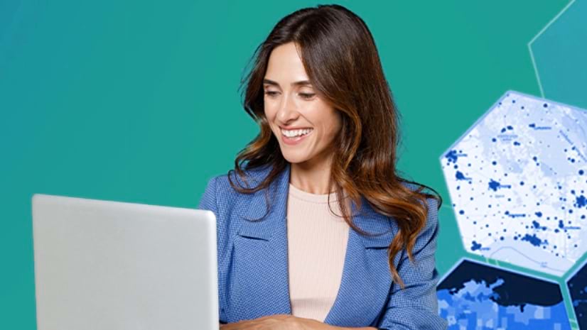 A person smiles at a laptop