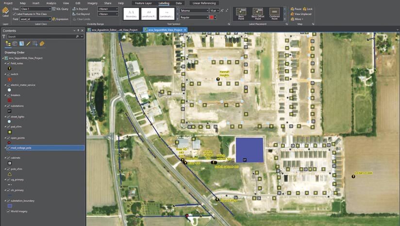Screenshot of GIS software showing a map of an area with power lines, transformers, and other utility infrastructure overlaid on an aerial photograph. The map includes labels identifying various components of the infrastructure and the location names Hannah Heights and Jordan's Creek. A legend on the left lists various infrastructure types.
