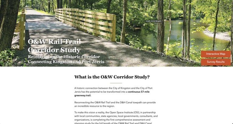 A scenic photo of a paved rail trail with a wooden fence, running alongside a calm river in a wooded area. The image is part of the home page of the O&W Rail Trail Corridor Study, which text on the page explains is a project to connect Kingston and Port Jervis with a continuous 57-mile greenway trail.