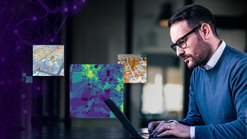 A person types on a laptop against a background of a blurred room and four colored map images