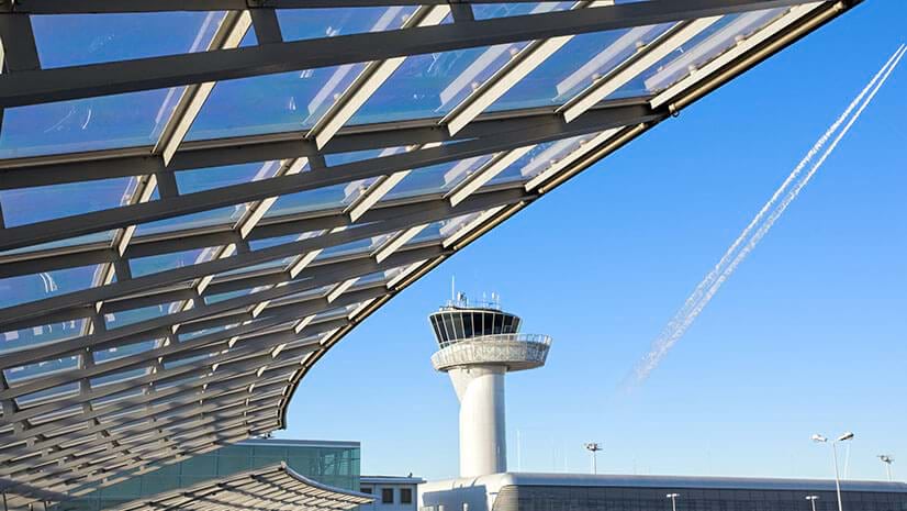 Infrastructure is highlighted with an airport roof and air traffic control tower.