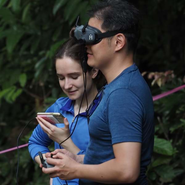 MOLRA field team members fly a drone at the XPRIZE Rainforest Semifinals in Singapore