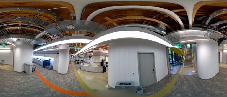 Photo of an office building interior distorted to show every angle of the viewer’s perspective in a rectangular field of view.