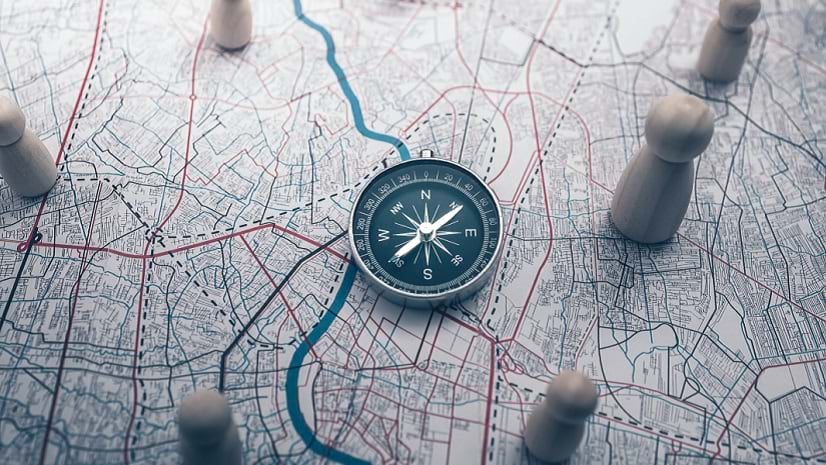 Geospatial strategy signified by a map, compass, and figurines