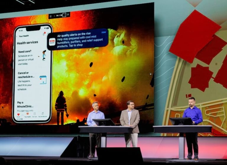 Three men standing on a stage giving a presentation