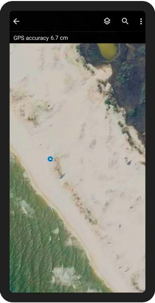 A mobile phone screenshot of the ArcGIS Field Maps interface showing a map of a coastline with a blue marker on it, indicating the location of a receiver.