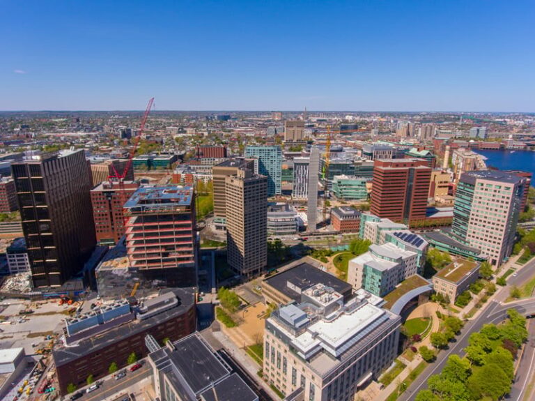 Aerial view of Cambridge, with mainly high-rises clustered around a city center.