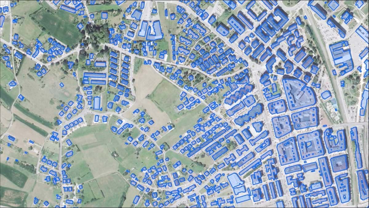 Map showing blue building footprints extracted by AI across urban and rural areas of Cantabria, displaying automated mapping capabilities