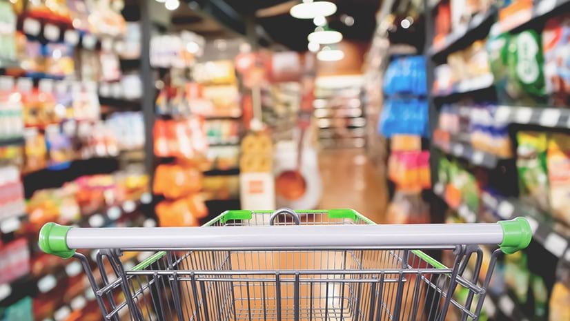 A shopping cart in a grocery store signifies retail foot traffic