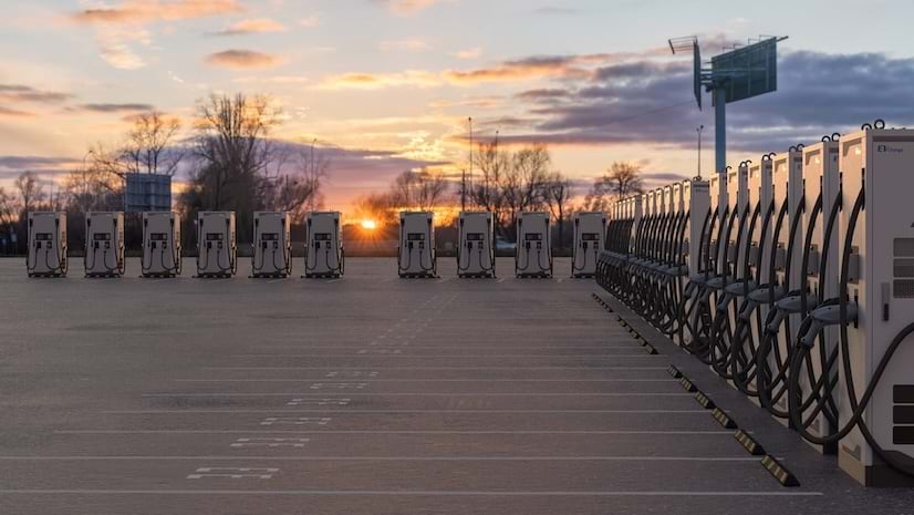 A row of EV chargers at dusk