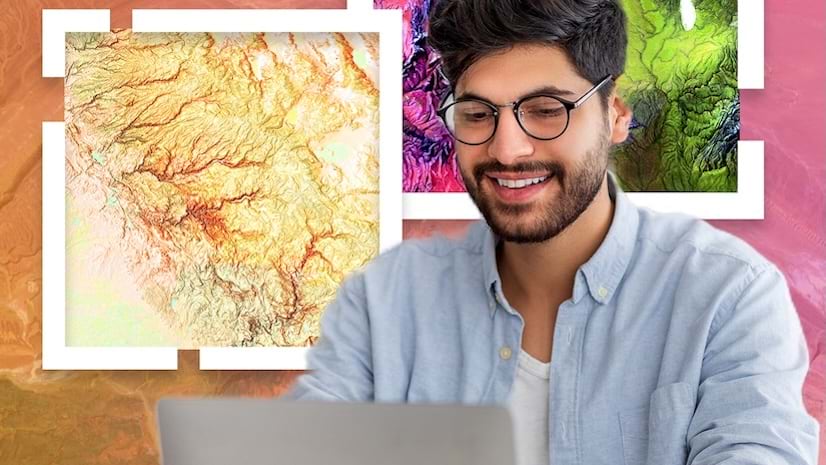A smiling young professional working on a laptop