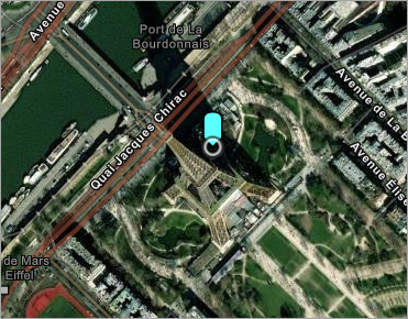 A web map of a region of Paris, France, with a sky blue GPS arrow near the Eiffel Tower