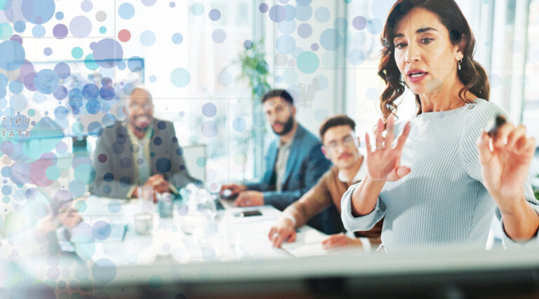 A woman leads a business meeting, gesturing at a whiteboard while others listen at the table. An overlay of circles and text appears on the image.