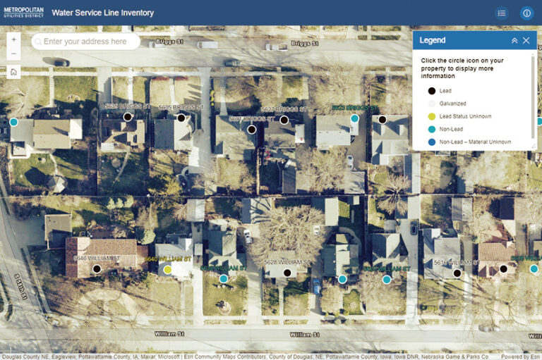 A screenshot of a Metropolitan Utilities District map showing a residential area with color-coded circles indicating the material of water service lines. The map has a legend distinguishing lead, galvanized, lead status unknown, non-lead, and non-lead-material unknown water lines.