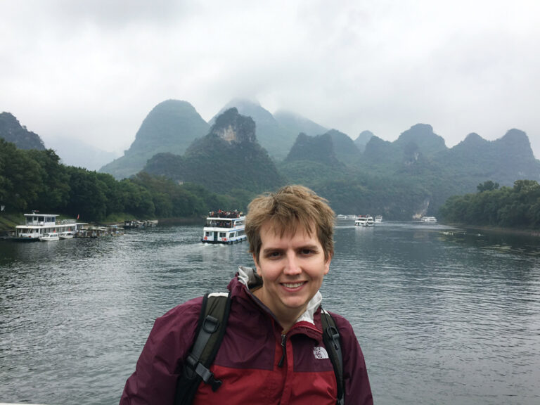 Map titled “Oceanic Oscillations: The World’s Tides at Their Greatest Ranges.” The maps is black, with a continuous, interconnected blue representing the world’s ocean’s as the central feature, and landmasses de-emphasized around the edges. A key on the lefthand side titled “Global Tidal Ranges” indicates that different shades of blue represent different tidal ranges, with the lightest being the greatest ranges.