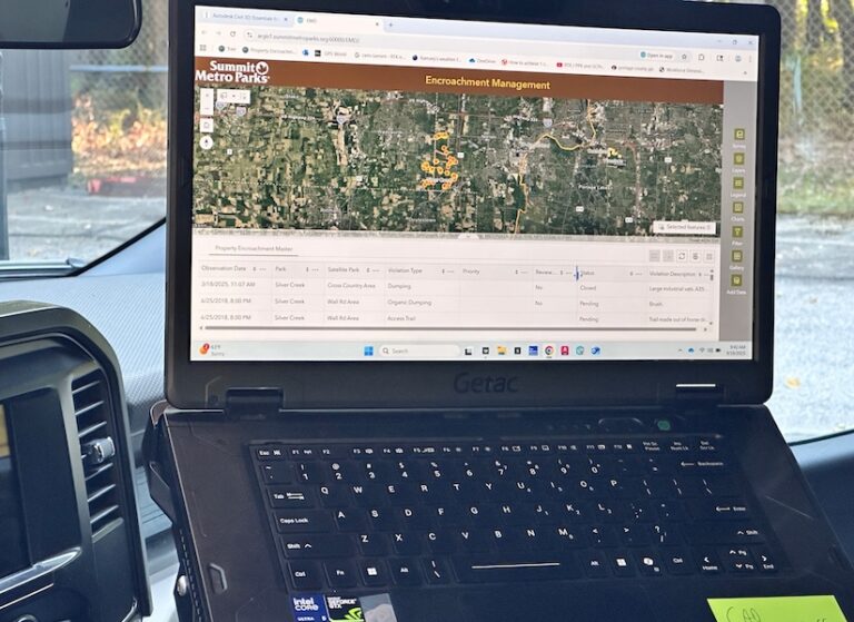 An open laptop displaying a map with the words encroachment management on top