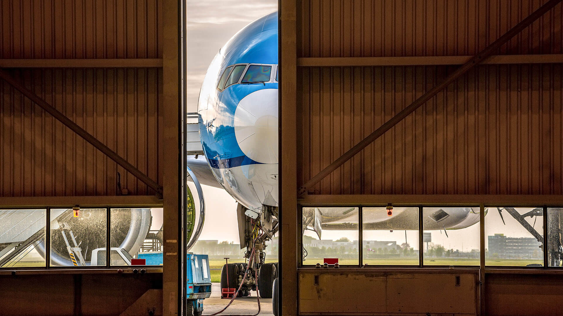 An airplane entering a hangar for spare parts or maintenance