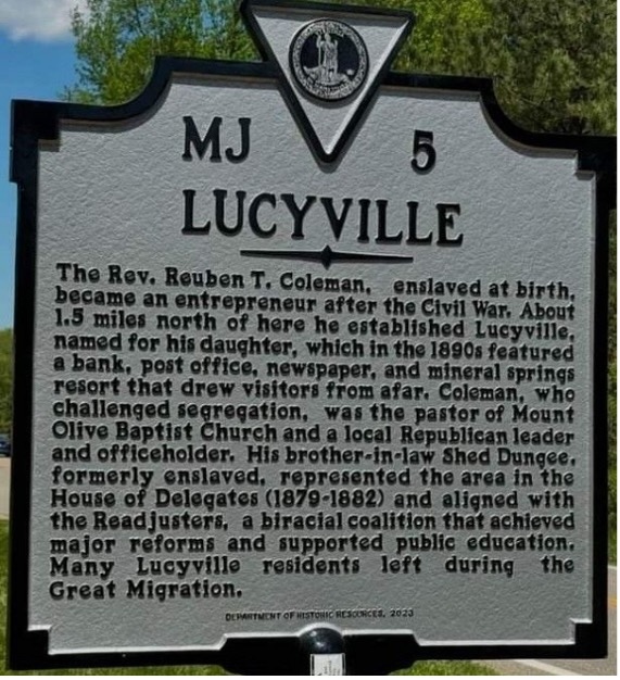 A white roadmarker with the word Lucyville at the top