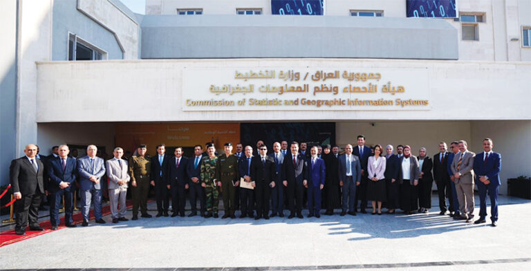 More than 30 people standing in front of a government building.