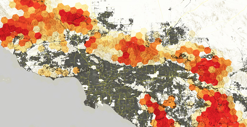 A heat map of a coastal area show dark gray urban development, mountainous terrain, and hexagonal clusters in yellow, orange, and red indicating high-intensity areas primarily in the mountains.
