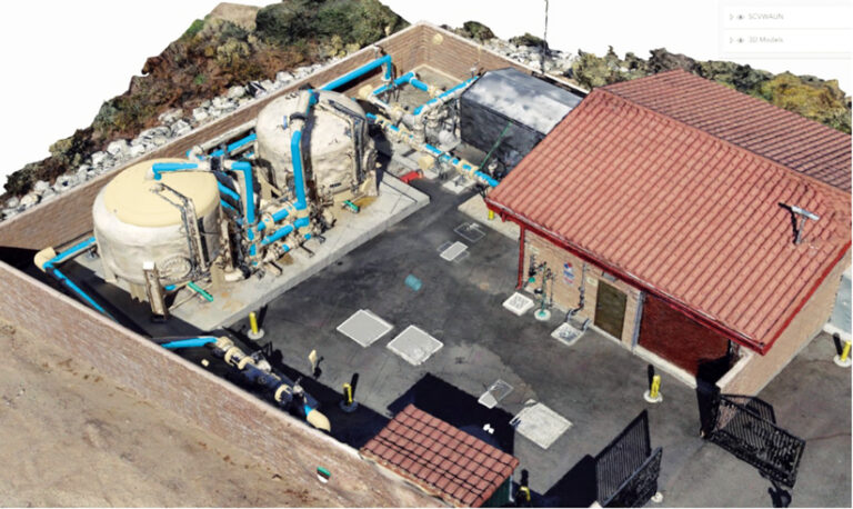 High-angle 3D model of an industrial facility: a brick building with a red tile roof, large tanks, and blue pipes, all within a walled enclosure.