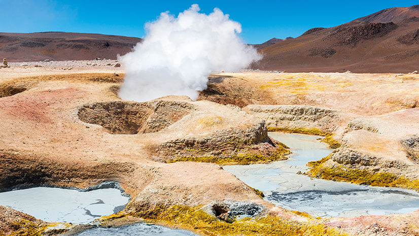 A steaming landscape indicates geothermal activity