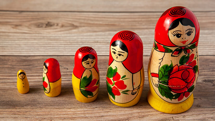 Colorful nesting dolls signify growth by acquisition