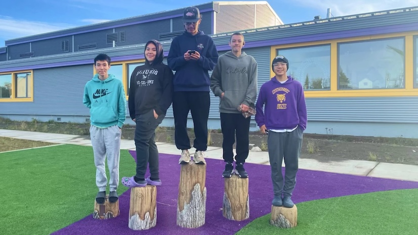Bristol Bay Region Career & Technical Education students in front of a school building