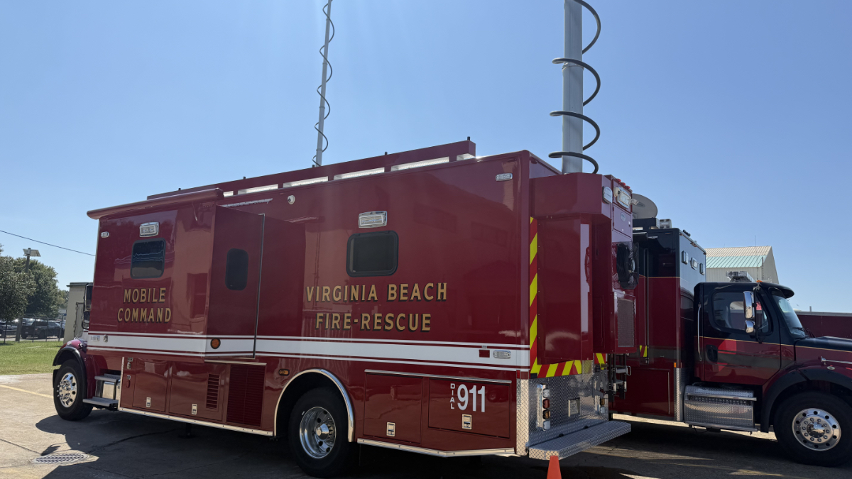 Virginia Beach Fire-Rescue mobile command vehicle with extended communication masts parked at an outdoor staging area.