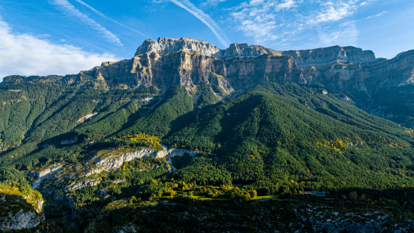 Aerial view of Monte Perdido\'s limestone massif rising above forested slopes in the Pyrenees mountains on the Spain-France border.