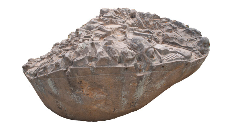 3D view of the Sayhuite Stone, a rounded granite boulder with densely carved relief figures representing the Inca empire, isolated on white.